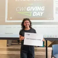Student holding sign expressing gratitude for CWI