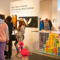 People in front of wall and art