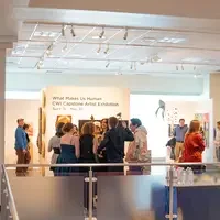 Groups of people chatting in front of art