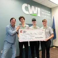 Winners pose with their large check