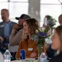 Erin Aboud listens on to speaker