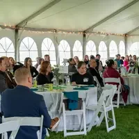 Groups of people sit at a table