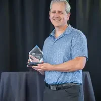 Advisor receiving an award