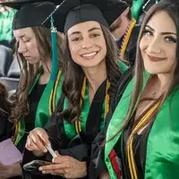 Graduate sitting and smiling