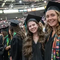 Two graduates smiling