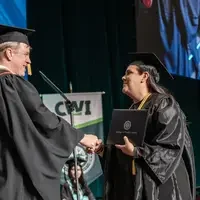Jones shaking hands with a graduate