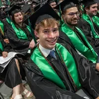 Graduate sitting and smiling