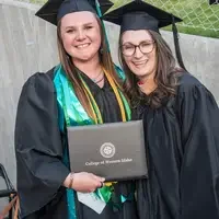 Two graduates smiling