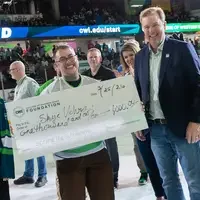 People hold a check