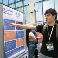 Student pointing at poster