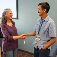Two people shake hands