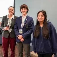 Three people pose for a picture