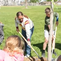 Adults and children plant a tree