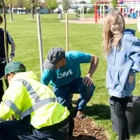 People gather around a hole to dig