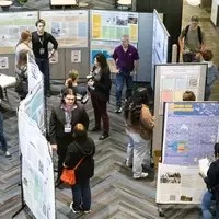 People gather around the poster competition