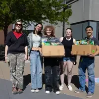 Chalk art students holding supplies