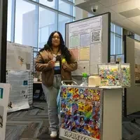 Student showcasing poster presentation