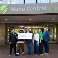group of people hold Idaho Steelheads check