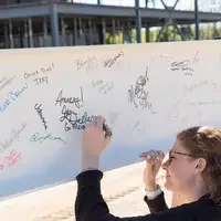 Person signing beam