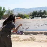 Person signing beam