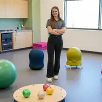 Gracie Young standing in pediatric lab with equipment surrounding her