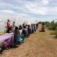 Students and staff enjoying food at an outdoor table