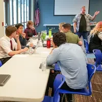 Instructor chats to audience in classroom