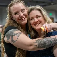 Students smiling and hugging