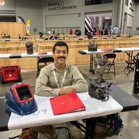 Franky Ramirez at his table with sculpture