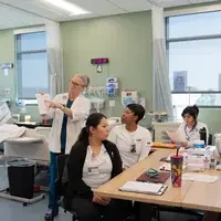 Instructor teaching students with materials