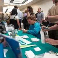 Students writing and filling out a form