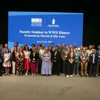 group of people standing in front of blue screen