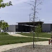 Two people sitting on a bench at the CWI Arboretum 
