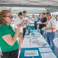 Students meet with resource tables on campus