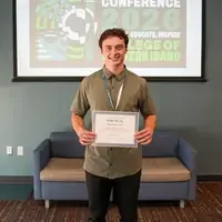 Kellan Brown holds a certificate