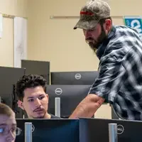 Instructor pointing to computer screen
