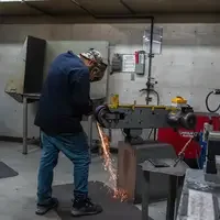 Student working on welding project in shop