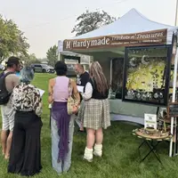 Students and faculty standing in front of art tent