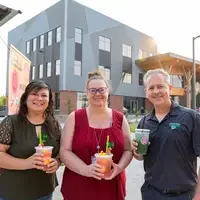 Three people smiling with lemonades