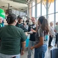 Groups of people stand in the lobby of CapEd Student Success Center