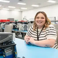 Bailey Guthrie sits at desk with equipment