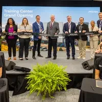A group of people pose for a ribbon-cutting ceremony at the Micron Training Center Grand Opening