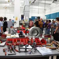 Group of student stand near equipment in HVAC lab