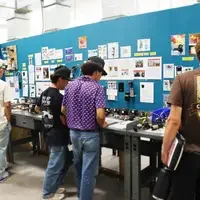 Students inspecting work bench with tools