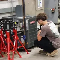 Student inspecting HVAC equipment