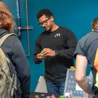 Micron employee showing students an activity