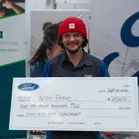 Nico Fease holding a large check