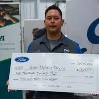 Jose Molina Segura holding a large check