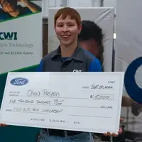 Olivia Preston holding a large check