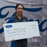 Giselle Amador holding a large check